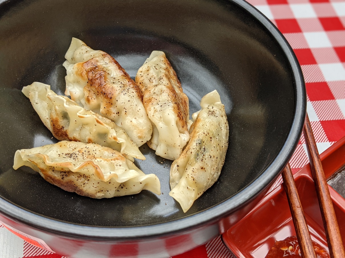 Pan-fried pork dumplings with soy-vinegar dipping sauce